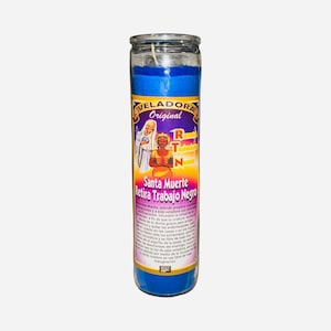 May include: A tall, cylindrical blue candle with a glass jar. The label reads "Veladora Original" and "Santa Muerte Retira Trabajo Negro" with illustrations of figures. The candle has a wick and is designed for spiritual use.