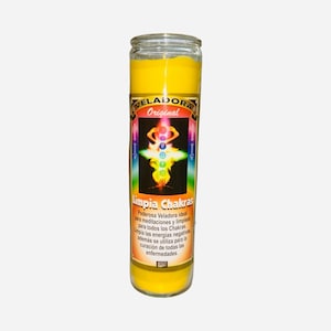 May include: A tall, yellow glass candle with a label featuring the text "VELADORA Original Limpia Chakras." The label includes a colourful illustration of the chakras. The candle is designed for meditation and cleansing.