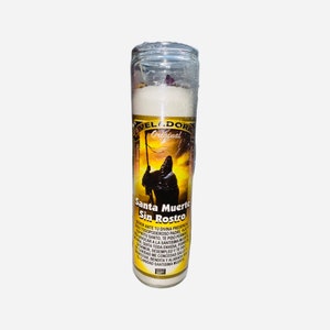 May include: A white candle with a yellow and black label featuring a skeletal figure. The label reads "VELADORA Original Santa Muerte Sin Rostro" and includes a prayer in Spanish.