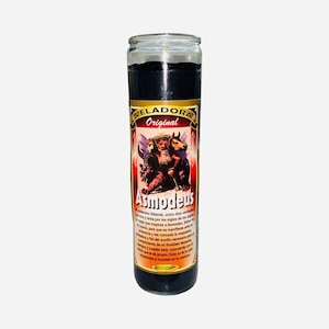 May include: A tall glass candle with black wax. The label features the word "VELADORA Original" and the name "Asmodeus" with an illustration of three figures. The candle is designed for spiritual or ritualistic purposes.