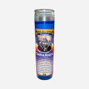 May include: A blue glass candle with a label that reads "VELADORA Original TUMBA BRUJOS". The label features an illustration of a person and text in Spanish. The candle is cylindrical and filled with blue wax.
