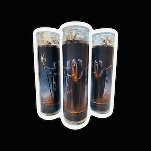 May include: Three glass candle jars with black and gold labels depicting a group of hooded figures holding a lantern. The candles are decorated with silver charms.