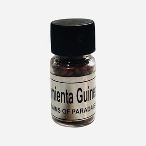 May include: A small glass bottle filled with brown seeds. The label reads "Pimienta Guinea Grains of Paradise".