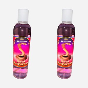 May include: Two clear glass bottles with pink liquid and white caps. The labels are red and gold with a snake image and the text "ORIGINAL" and "Para Separar".