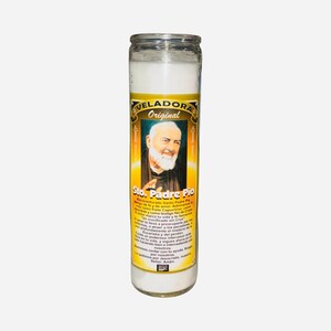 May include: A white candle in a clear glass jar. The label features an image of a man with a white beard and the text "VELADORA Original Sto. Padre Pio". The candle is cylindrical and has a metal lid.