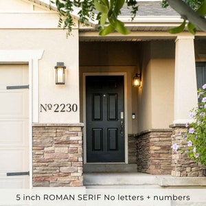 ROMAN SERIF No. sign letters and house numbers on a craftsman home. Garage number sign on stucco