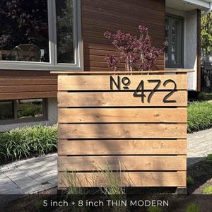 THIN MODERN 5 inch  8 inch black address numbers No. 472 on a fence in the front yard landscaping