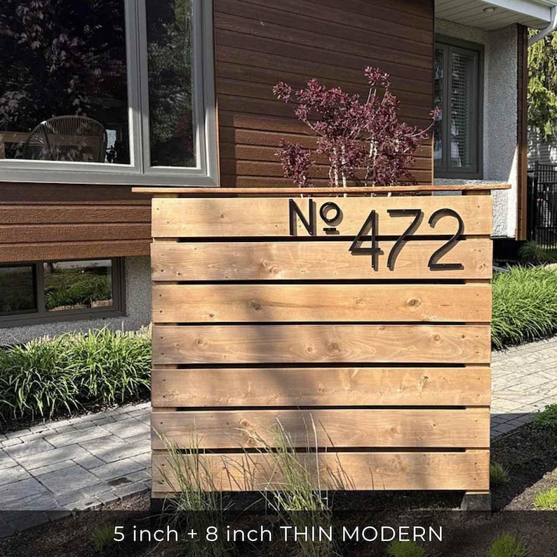 THIN MODERN 5 inch  8 inch black address numbers No. 472 on a fence in the front yard landscaping