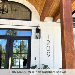 8 inch THIN MODERN house numbers on Modern Farmhouse with white siding, black trim and cedar details