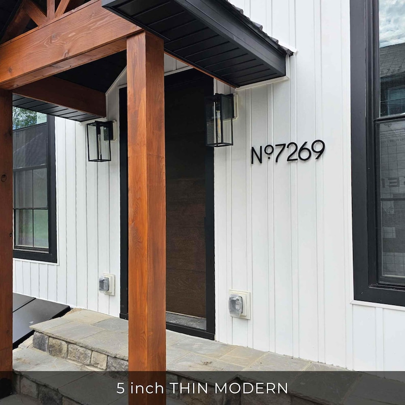 THIN MODERN 5 inch black address numbers on white siding beside a black front door