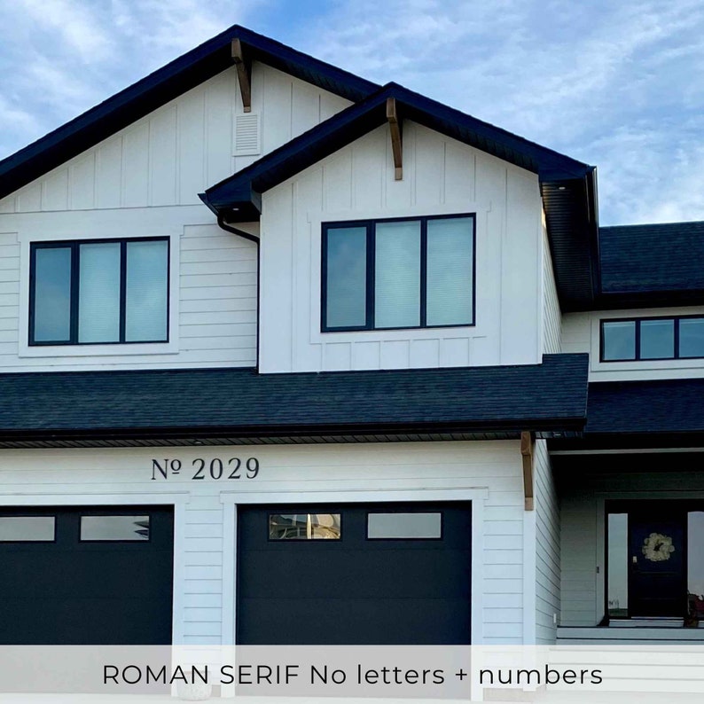 ROMAN SERIF house numbers and No sign letters on a Modern farmhouse exterior. House number sign for a home with black trim and doors.