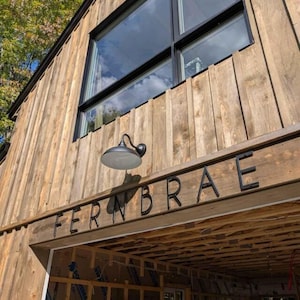 THIN MODERN 8 inch letters spelling FERNBRAE on wood siding for AIRBNB signage
