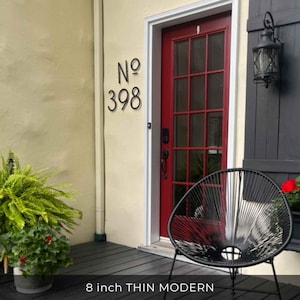 THIN MODERN 8 inch black address numbers No. 398 on stucco beside a red front door