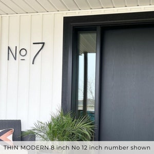 A modern farmhouse number sign  with 8 inch THIN MODERN No letters and 12 inch number fastened with screws and spacers.