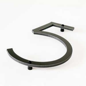 8 inch tall THIN MODERN house number 5 shown from the side and on an angle showing the spacers that help the number stand out from the siding