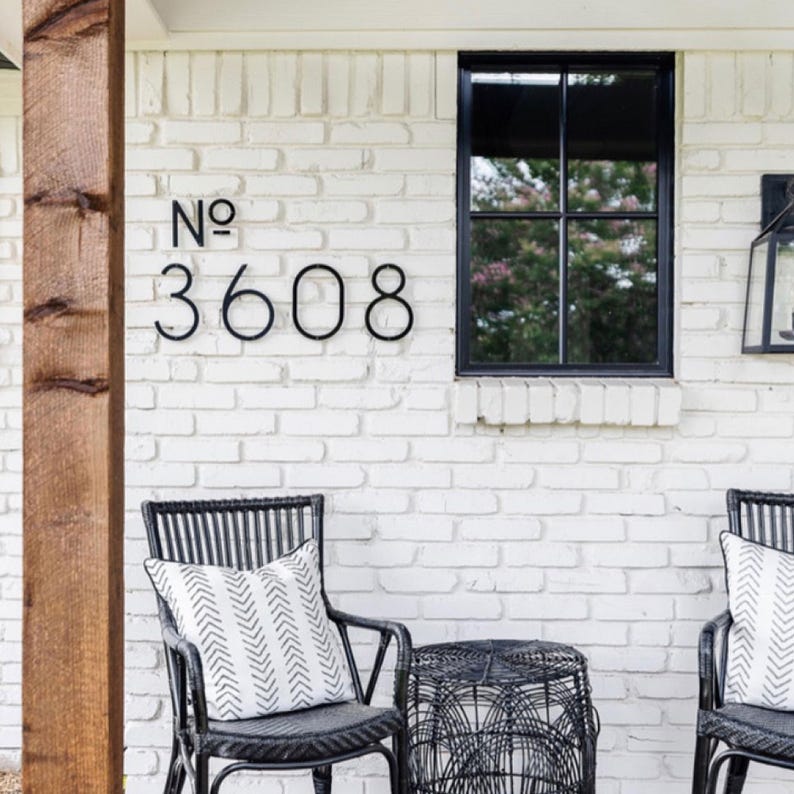 A modern house number sign with 5 inch THIN MODERN No letters and 8 inch numbers fastened with screws and spacers.