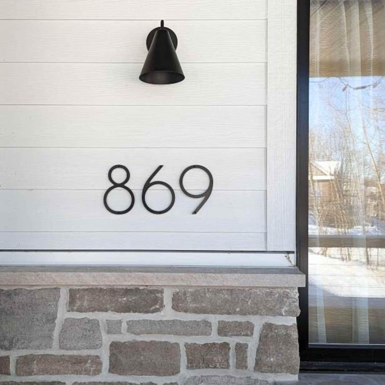 THIN MODERN 8 inch black address numbers 869 on white siding above stone facade