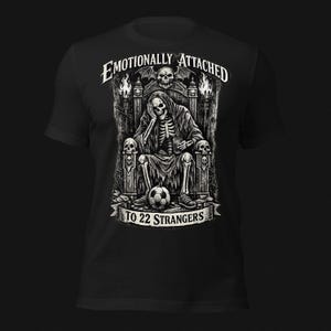 Emotionally Attached To 22 Strangers gothic football fan shirt featuring a frustrated skeleton sitting on a throne with a soccer ball, dark humor sports tee, gothic soccer shirt, vintage skeleton artwork, football lover gift, alternative fashion, dark academia style, soccer supporter apparel, unique football fan clothing, match day shirt, gothic sports design, unisex football t shirt.