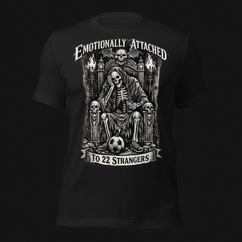 Emotionally Attached To 22 Strangers gothic football fan shirt featuring a frustrated skeleton sitting on a throne with a soccer ball, dark humor sports tee, gothic soccer shirt, vintage skeleton artwork, football lover gift, alternative fashion, dark academia style, soccer supporter apparel, unique football fan clothing, match day shirt, gothic sports design, unisex football t shirt.