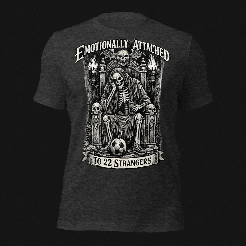 Emotionally Attached To 22 Strangers gothic football fan shirt featuring a frustrated skeleton sitting on a throne with a soccer ball, dark humor sports tee, gothic soccer shirt, vintage skeleton artwork, football lover gift, alternative fashion, dark academia style, soccer supporter apparel, unique football fan clothing, match day shirt, gothic sports design, unisex football t shirt.