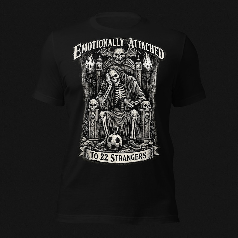 Emotionally Attached To 22 Strangers gothic football fan shirt featuring a frustrated skeleton sitting on a throne with a soccer ball, dark humor sports tee, gothic soccer shirt, vintage skeleton artwork, football lover gift, alternative fashion, dark academia style, soccer supporter apparel, unique football fan clothing, match day shirt, gothic sports design, unisex football t shirt.