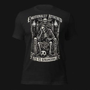 Emotionally Attached To 22 Strangers gothic football fan shirt featuring a frustrated skeleton sitting on a throne with a soccer ball, dark humor sports tee, gothic soccer shirt, vintage skeleton artwork, football lover gift, alternative fashion, dark academia style, soccer supporter apparel, unique football fan clothing, match day shirt, gothic sports design, unisex football t shirt.