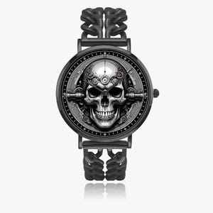 A black wristwatch with a skull and gears design on the face. The watch has a black metal band with a chain-link pattern.
