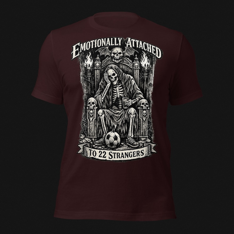 Emotionally Attached To 22 Strangers gothic football fan shirt featuring a frustrated skeleton sitting on a throne with a soccer ball, dark humor sports tee, gothic soccer shirt, vintage skeleton artwork, football lover gift, alternative fashion, dark academia style, soccer supporter apparel, unique football fan clothing, match day shirt, gothic sports design, unisex football t shirt.