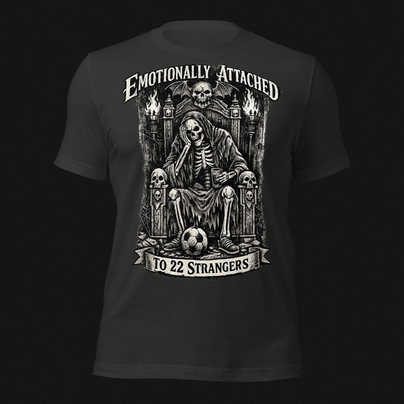 Emotionally Attached To 22 Strangers gothic football fan shirt featuring a frustrated skeleton sitting on a throne with a soccer ball, dark humor sports tee, gothic soccer shirt, vintage skeleton artwork, football lover gift, alternative fashion, dark academia style, soccer supporter apparel, unique football fan clothing, match day shirt, gothic sports design, unisex football t shirt.