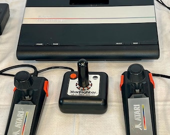 Vintage Atari 7800 ProSystem video game console and controllers and games lot.