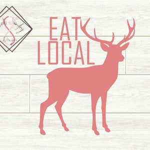Puede incluir: Una silueta rosa de un ciervo con cuernos, de pie sobre un fondo de madera blanca. El texto "EAT LOCAL" está escrito en negro sobre el ciervo.
