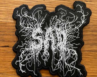 Sad woven iron on patch