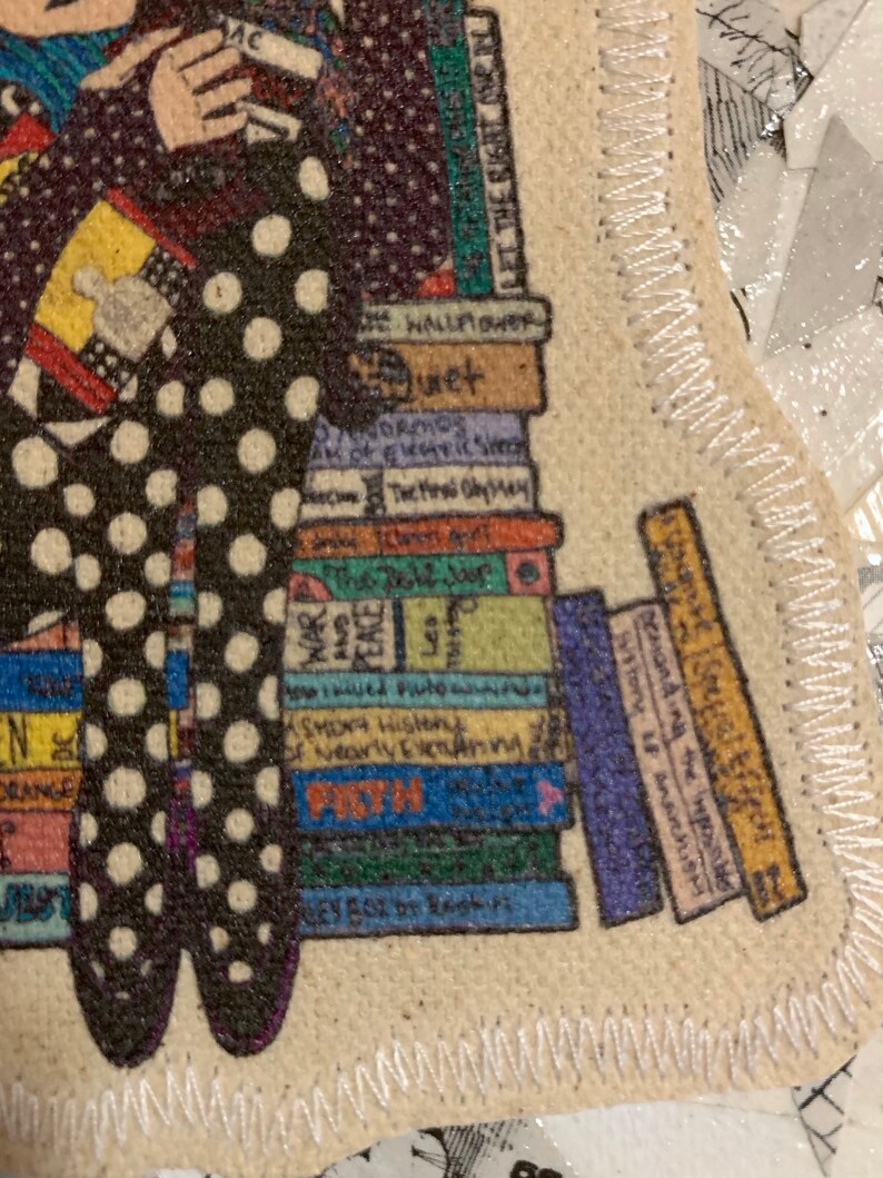 May include: A colourful illustration of a woman sitting on a stack of books. The woman is wearing a black and white polka dot dress and holding a book. The books have titles such as "The Hall Flower", "Normos", "Shoya History", "Demanding the History of anarchISH", and "Peace".