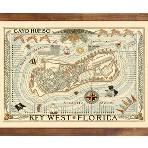 May include: A framed vintage map of Key West, Florida, with the text "CAYO HUESO" at the top. The map features illustrations of ships, sea creatures, and a compass rose. The frame is made of dark brown wood.