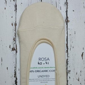Rosa no show white sock stretched on a labelled cardboard on a white wooden floor