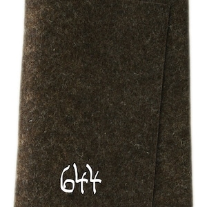 May include: A dark brown felt sheet with the number 644 written in white on it.