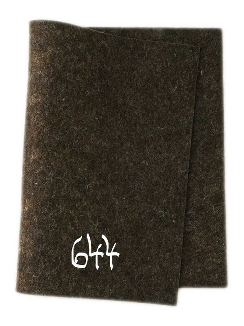 May include: A dark brown felt sheet with the number 644 written in white on it.