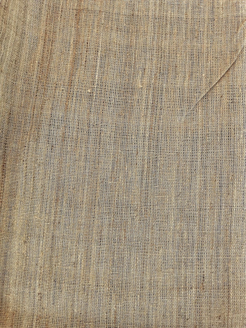 May include: A close-up of a brown burlap fabric with a woven texture. The fabric has a natural, rustic look and feel.