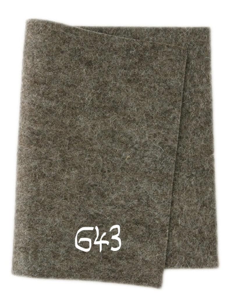 May include: A brown felt sheet with the number 643 written in white on it.