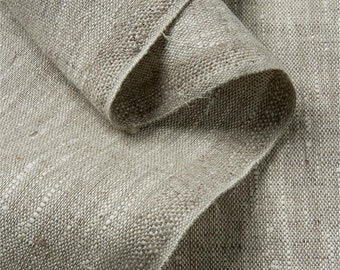 May include: Close-up of a natural linen fabric with a textured weave. The fabric is a light beige color and has a slightly rough feel.