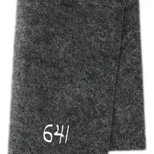 May include: A dark grey felt fabric with the number 624 printed in white.