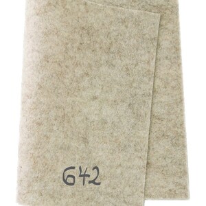 May include: A beige felt sheet with the number 642 written on it.
