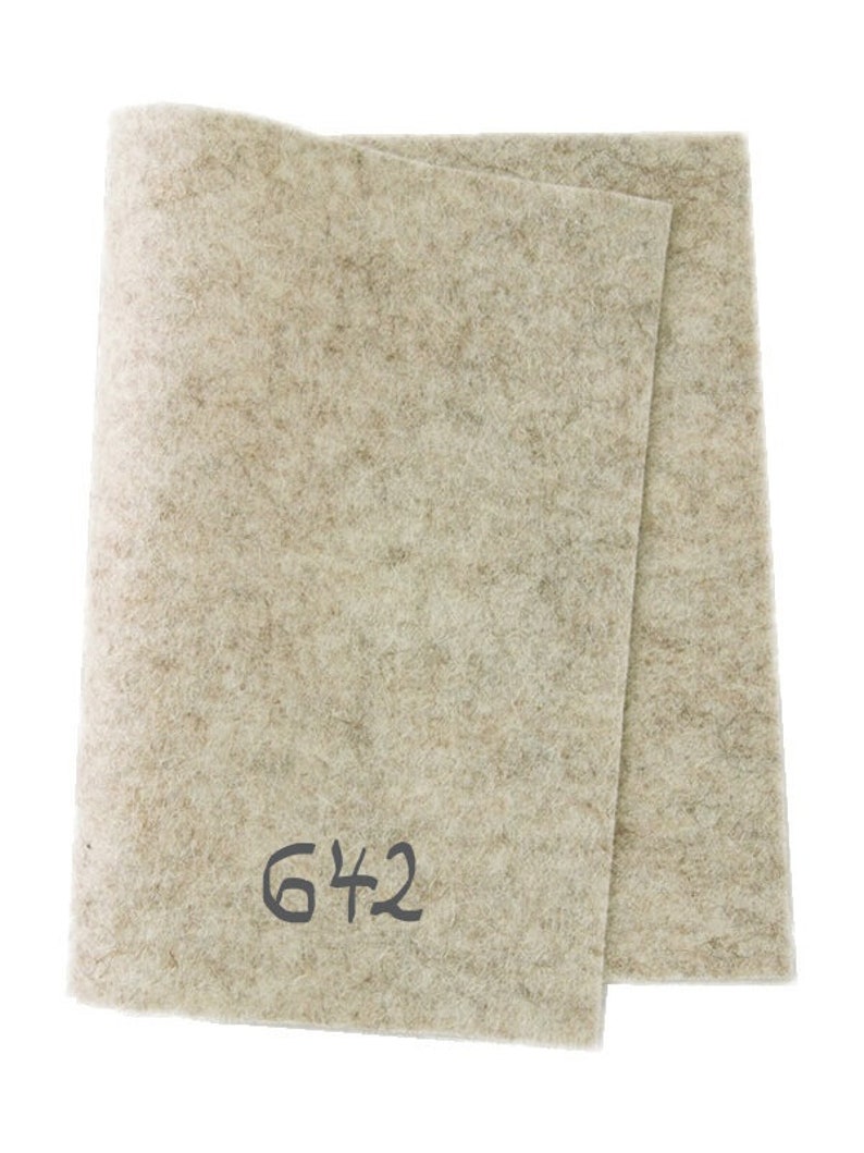 May include: A beige felt sheet with the number 642 written on it.