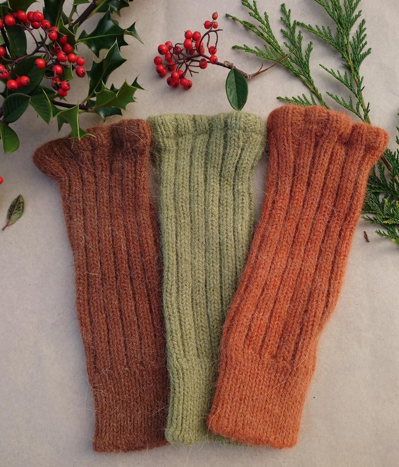 Naturally dyed handwarmers in ginger biscuit, foxy orange and christmas green