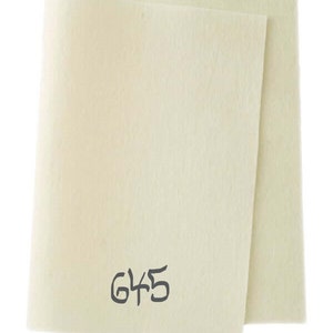 May include: A sheet of white felt with the number 645 printed on it.