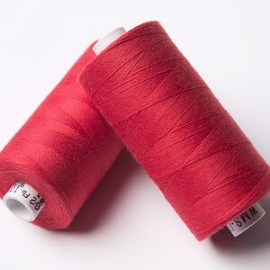May include: Two spools of red thread, one labelled "WM45" and the other "825 F-P".