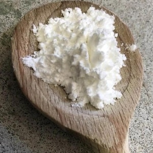 以下が含まれることがあります： 白い粉末、おそらくベーキングパウダーまたはコーンスターチが入った木製のさじ