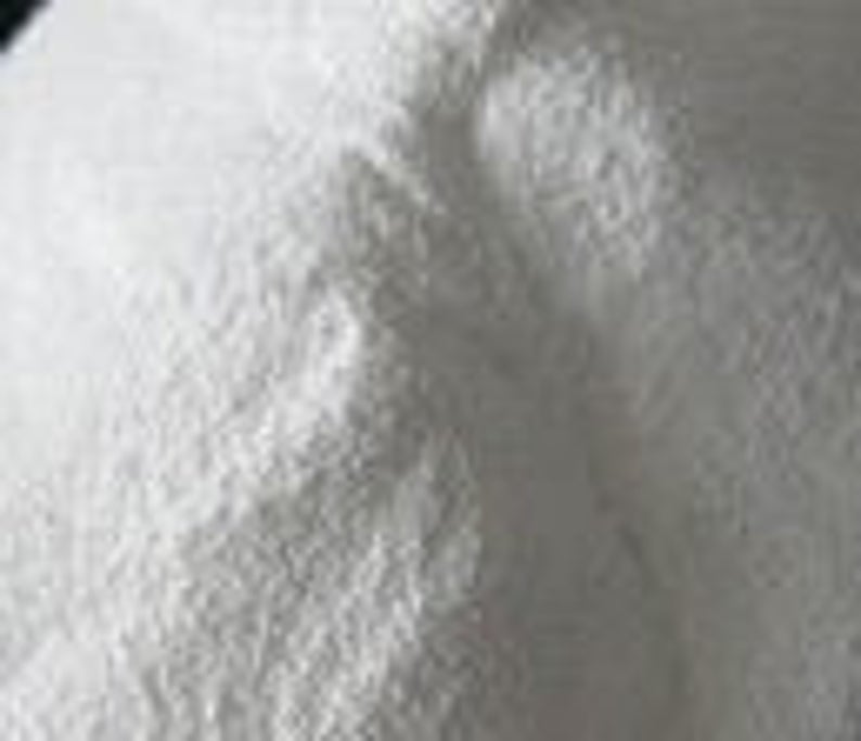 May include: A close-up of a white powder, likely a baking ingredient like flour or powdered sugar.
