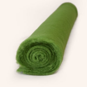 May include: A roll of green felt fabric. The felt is soft and fuzzy, and it is rolled up tightly.