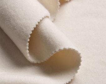 May include: Close-up of a soft, white fabric with a slightly textured surface. The fabric is folded over itself, creating a smooth, curved shape.